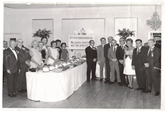 A group of Feeser's executives gather around a dining hall in the early 1900's.