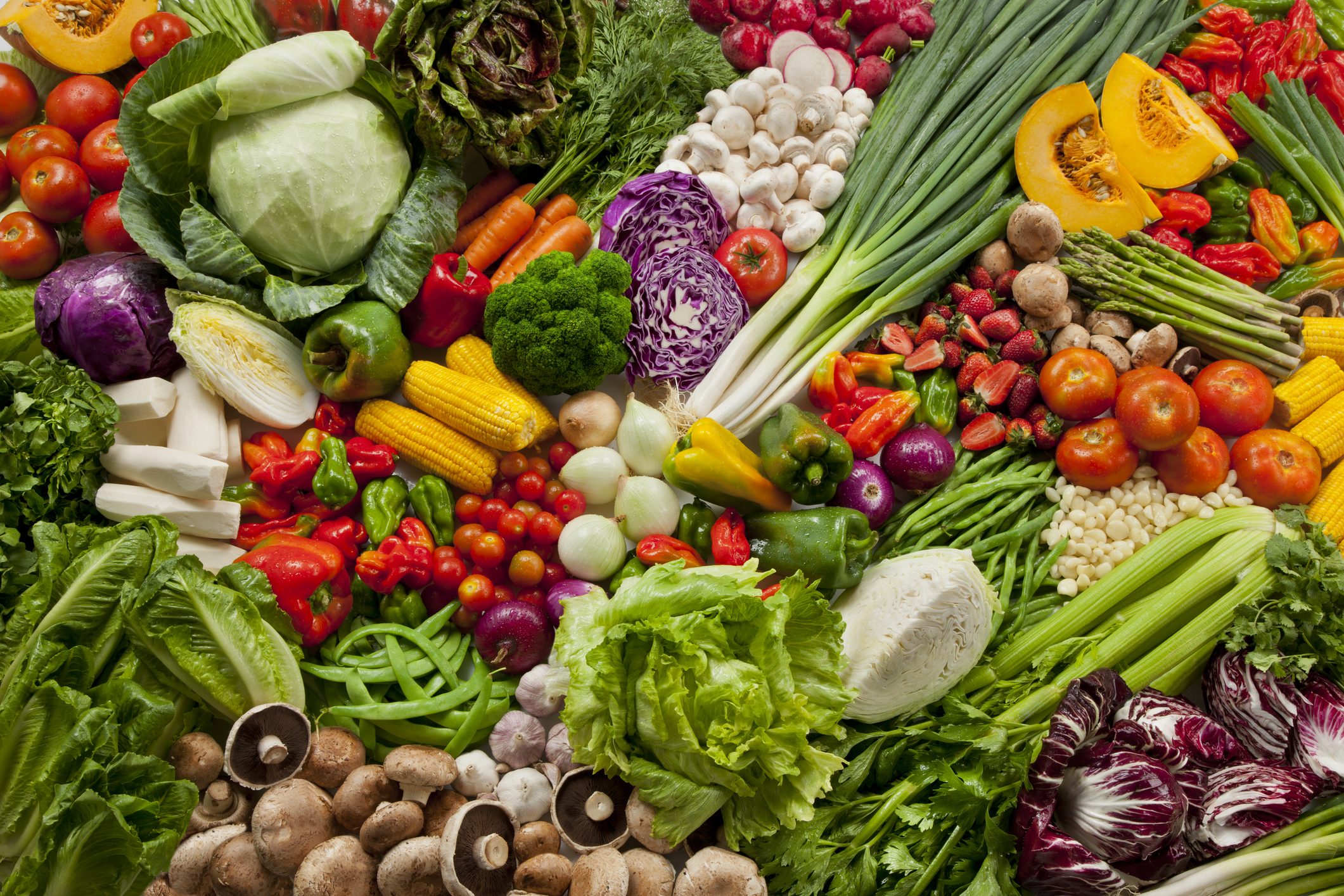 A wide display of different kinds of greens, fruits, and vegetables