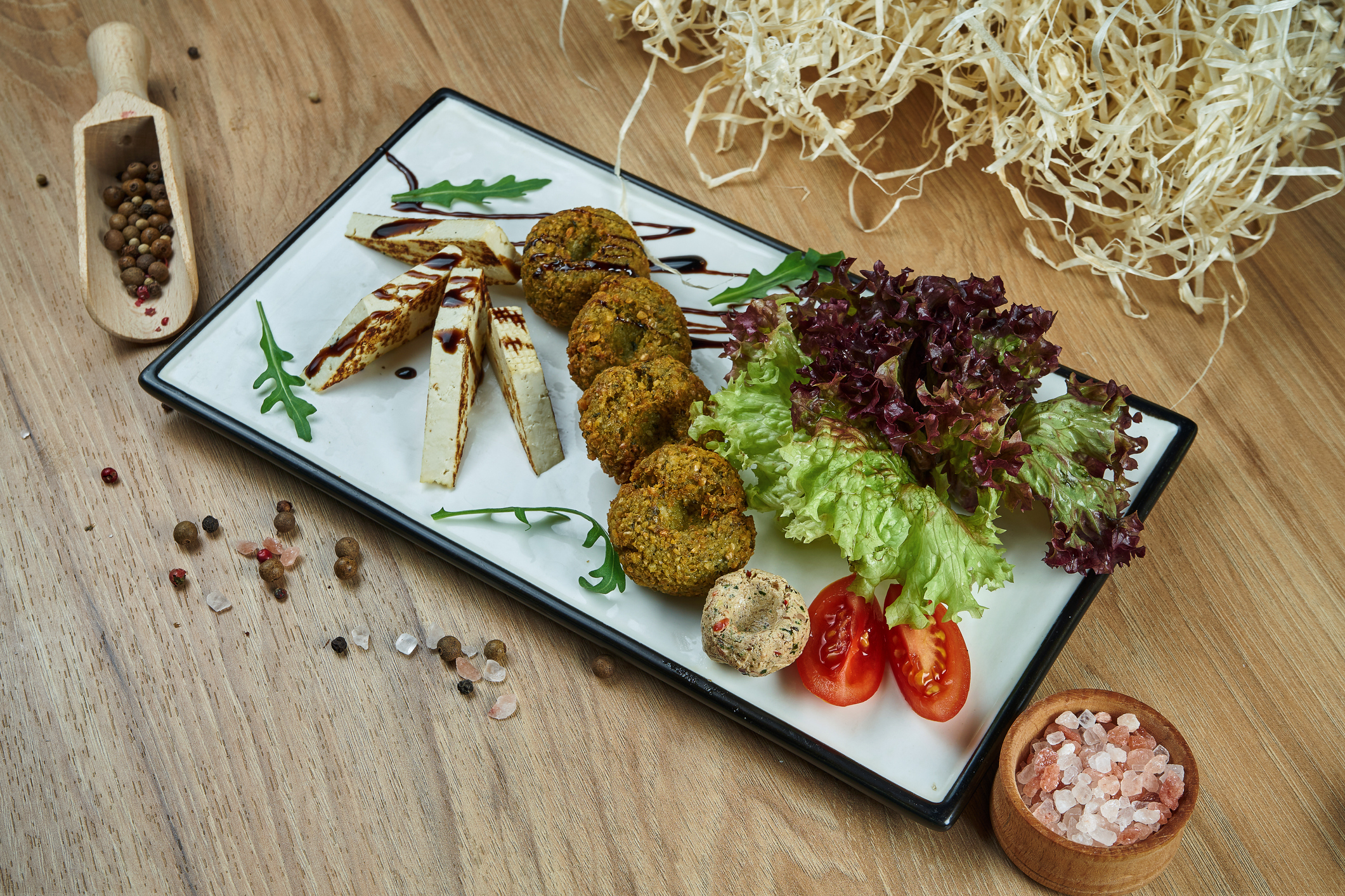 Falafel served on a plate with fresh greens.