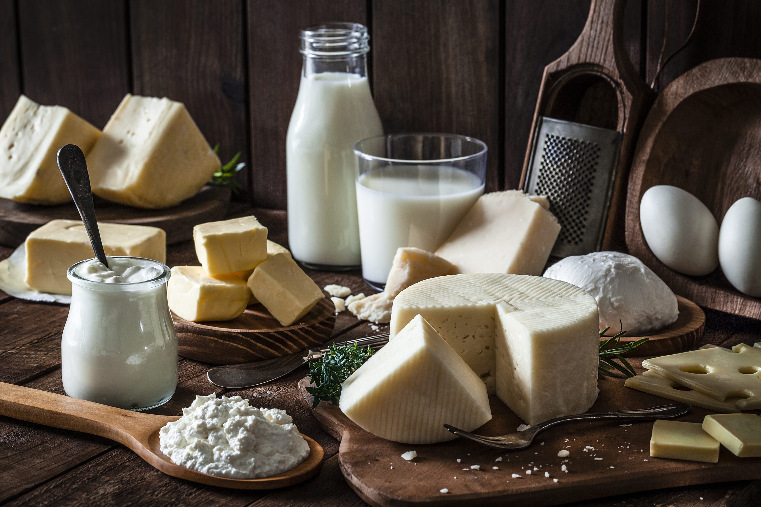 An assortment of artisan cheeses are displayed on a wooden table