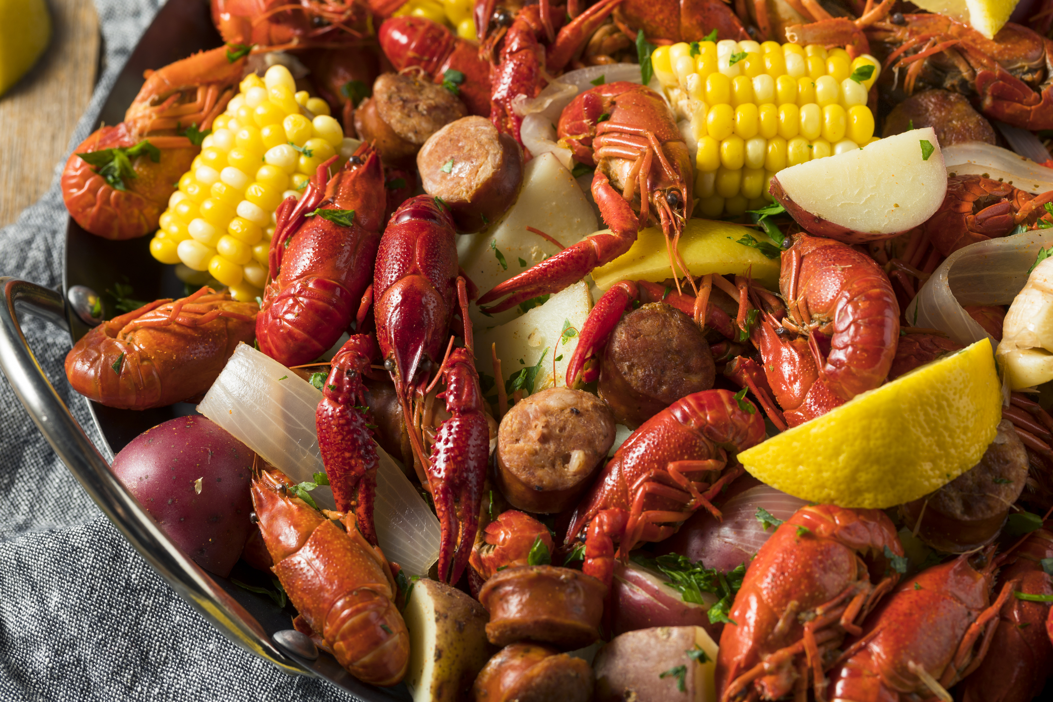 A fresh Cajun seafood bake consisting of shrimp, crayfish, sausage, corn, and potatoes.