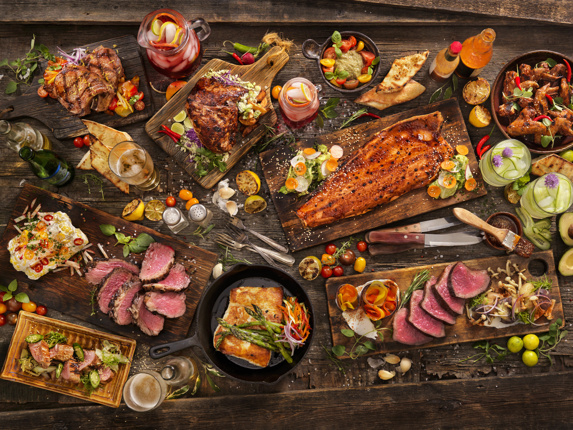 Assorted cuts of meat on a wooden table.