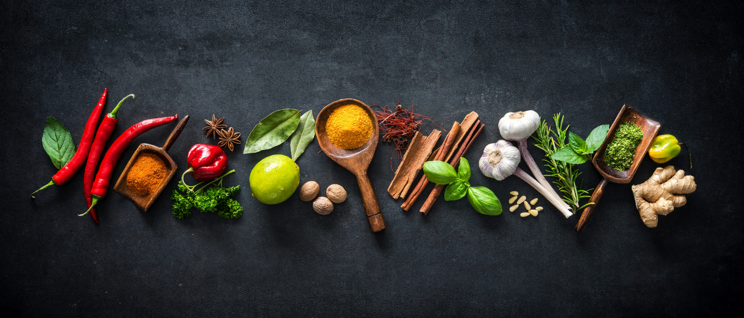 Different herbs and spices laid out on a table.