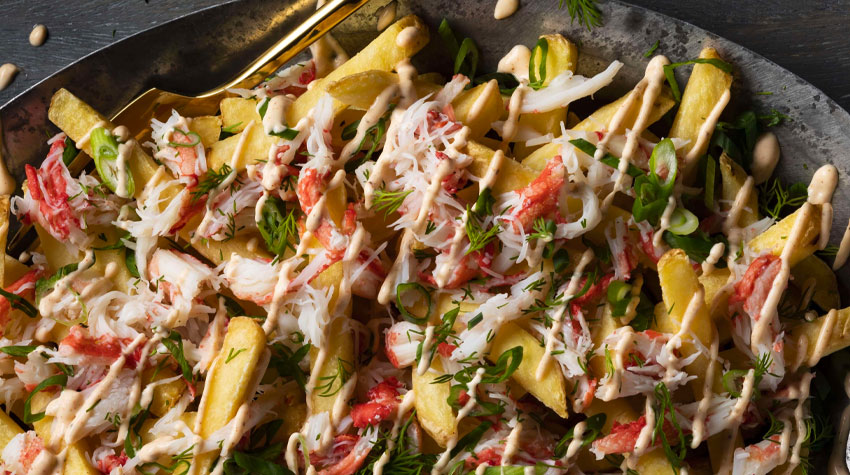 Loaded French fries with crab meat and smoked paprika garlic aioli