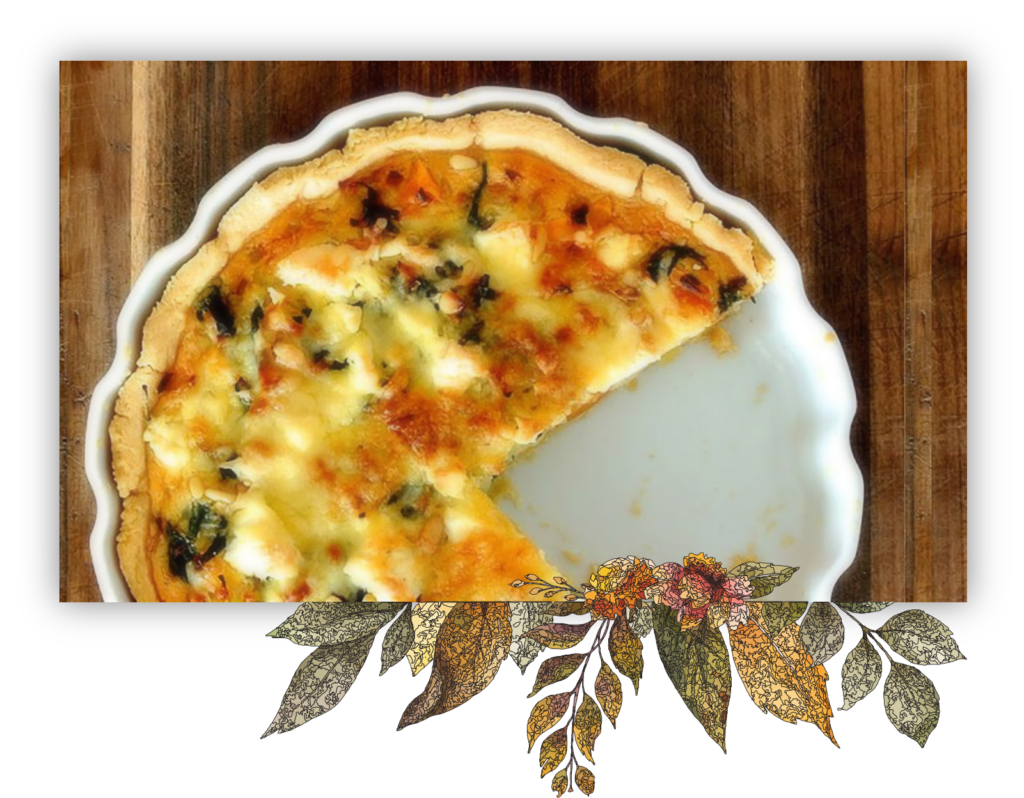 a quiche with a slice taken out of it