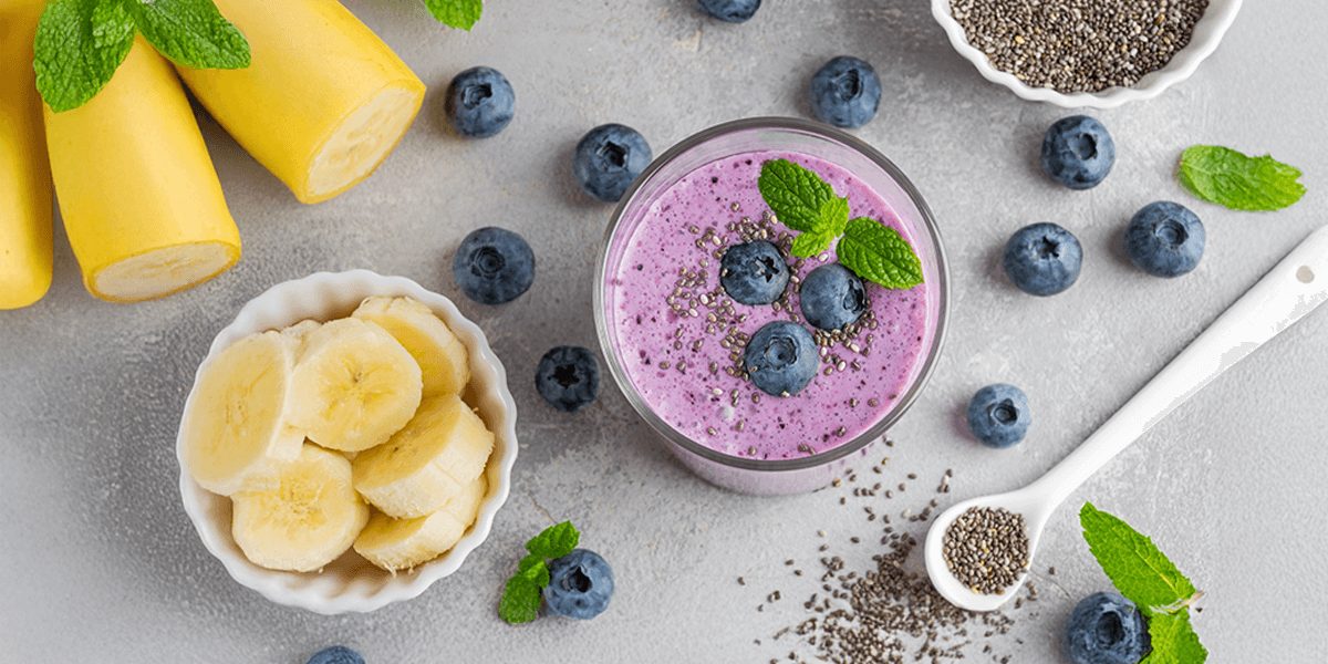 bowl of bananas and smoothie with blueberries