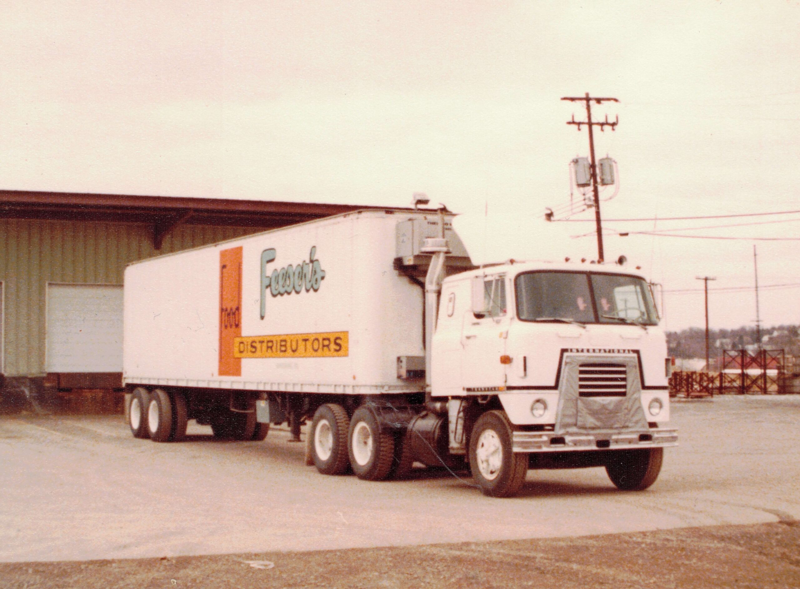 an old school white delivery truck with the Feeser's logo on it
