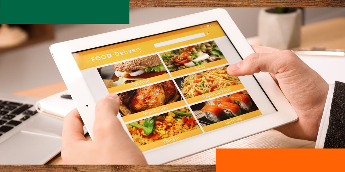 a person holding a tablet with a food delivery system on the screen